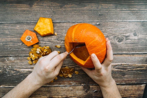 Carving Halloween pumpkin on table