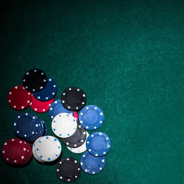 Casino chips on green poker table