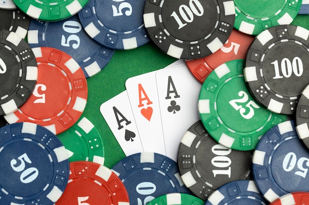 Free photo casino tokens on green background with ace cards