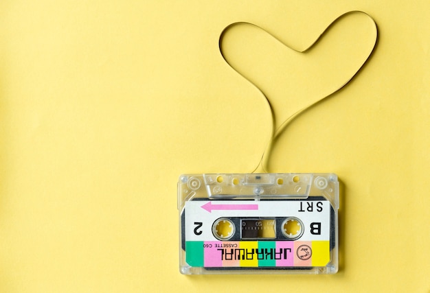 Cassette tape with a heart symbol isolated on yellow background