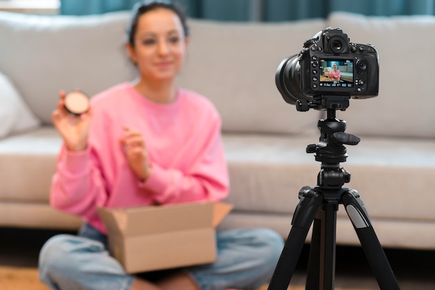 Casual blogger with glasses in front of camera and doing unboxing