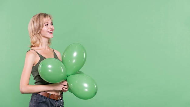 Casual dressed woman holding balloons