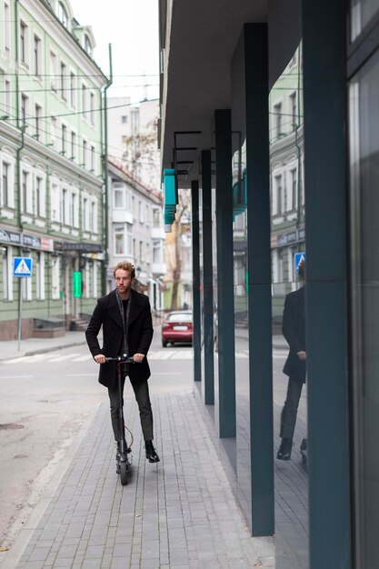 Casual male riding an electric scooter