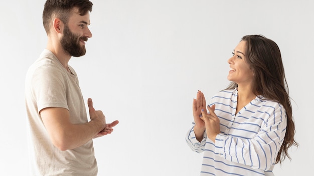 Free photo casual man and woman communicating through sign language