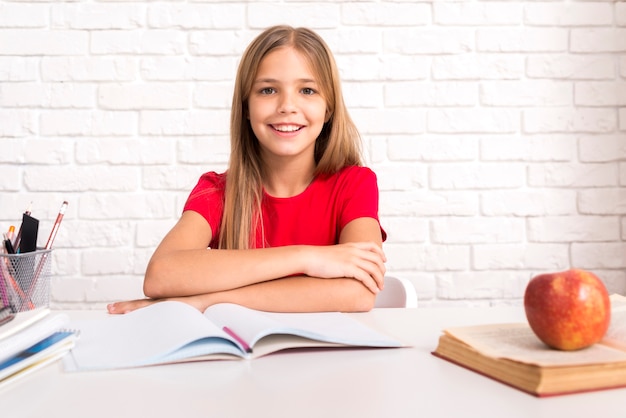 Casual schoolgirl sitting at desk