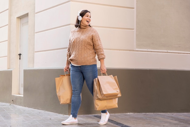 Casual teenager carrying shopping bags