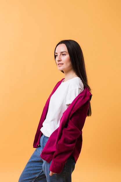 Casual woman posing with an orange background