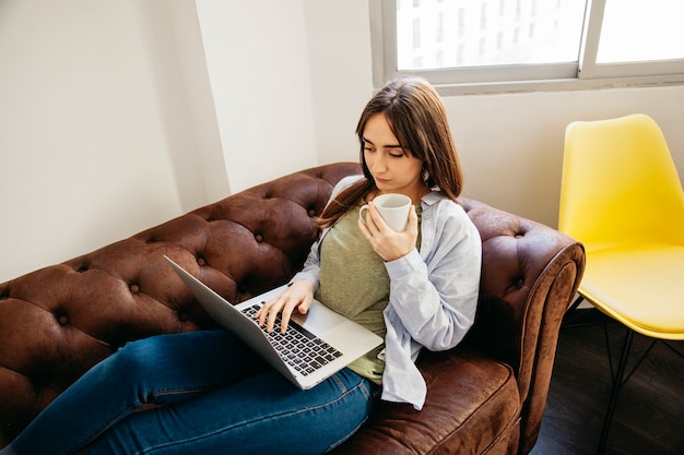 Casual woman relaxing with laptop