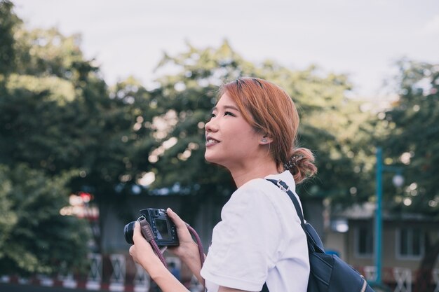 Casual woman taking photos of city