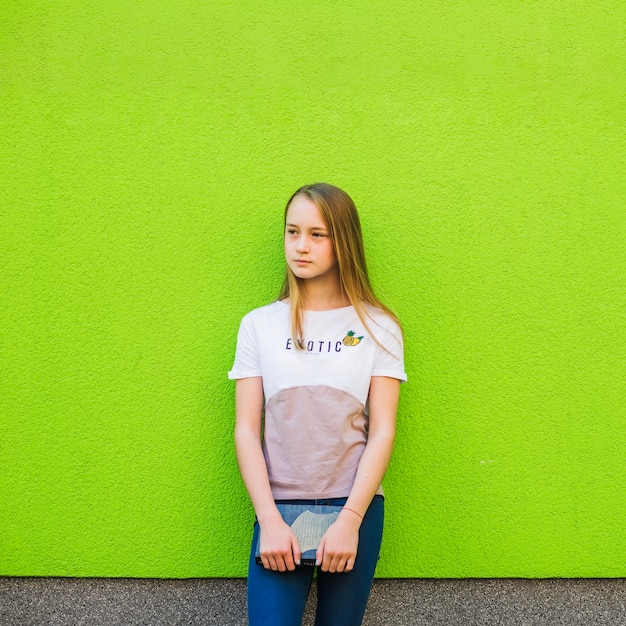 Casual youngster standing with book