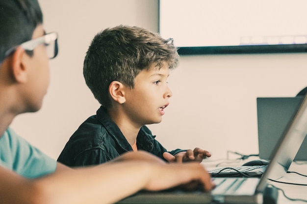 Free Photo caucasian boy reading task aloud during lesson