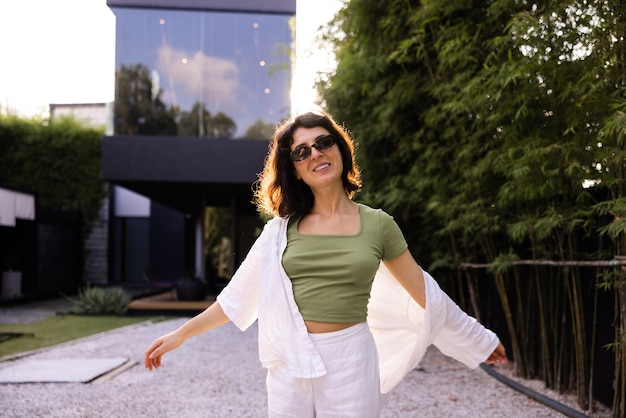 Caucasian brunette woman in sunglasses look at camera