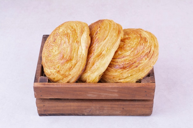 Free photo caucasian gogal buns in a wooden tray.