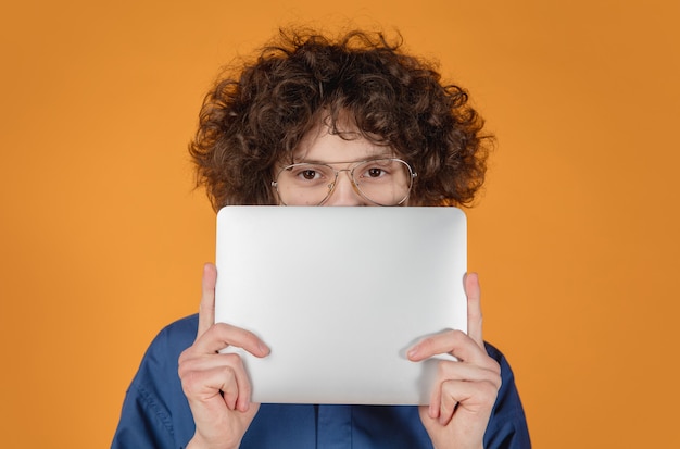 Caucasian handsome young man's portrait isolated on yellow  background with copyspace.