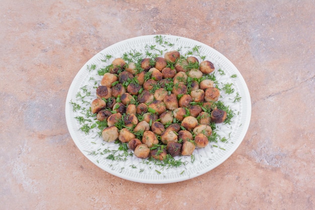 Caucasian khinkal stuffings fried and served with chopped herbs.