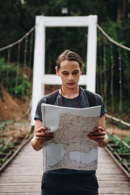 Free Photo caucasian man looking at a map travel and explore concept