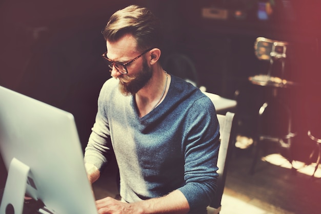 Free Photo caucasian man sitting working on computer pc