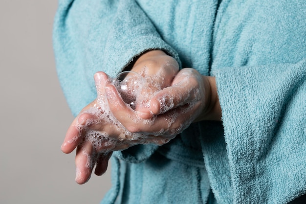 Free photo caucasian person washing hands with soap