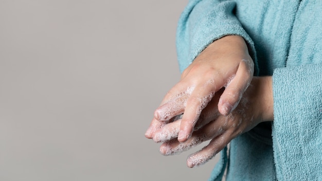 Free photo caucasian person washing hands with soap