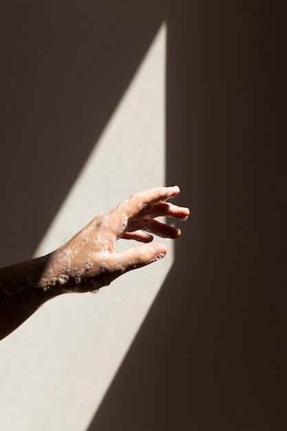 Caucasian person washing hands with soap