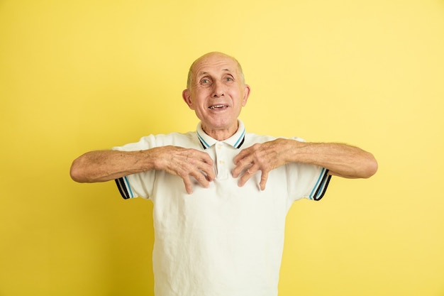 Free photo caucasian senior man's portrait isolated on yellow wall