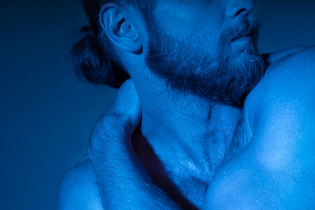 Caucasian shirtless man in blue tones