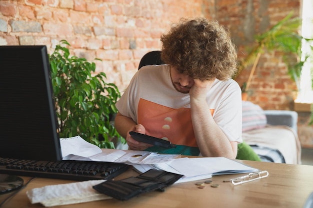 Caucasian upset and despair man doing financial and economical reports