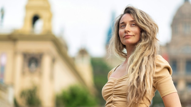 Free Photo caucasian woman in dress with view of barcelona on the background, spain