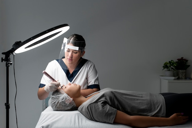 Free Photo caucasian woman going through a microblading treatment