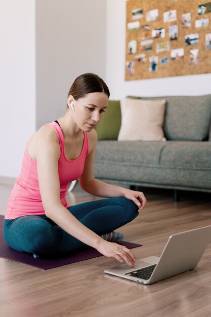 Caucasian woman practicing yoga at home