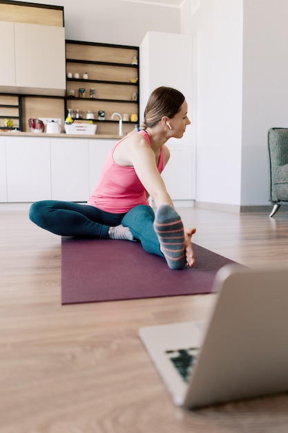 Caucasian woman practicing yoga at home