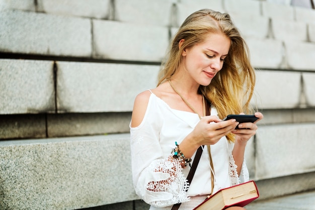 Caucasian woman using mobile phone outdoors