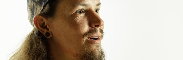 Caucasian young man's close up shot on studio, flyer