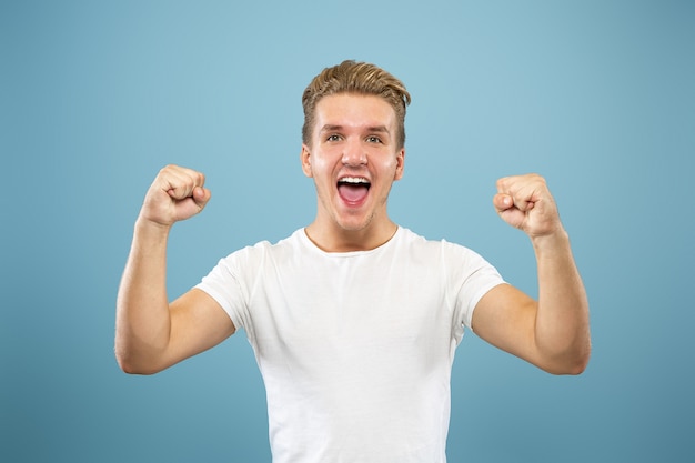 Free photo caucasian young man's half-length portrait on blue studio