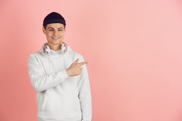 Caucasian young man's modern portrait on pink studio