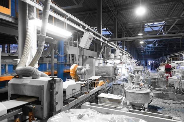 Free photo cement factory interiors industrial cement production conveyor workers in the shop on the production line