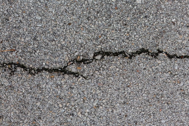 Cement surface with rocks and crack