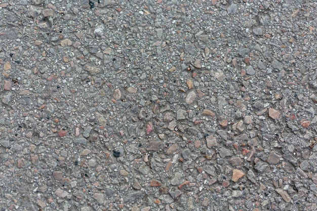 Cement surface with rocks and pebbles