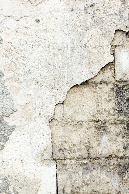 Cement wall with exposed dirty bricks