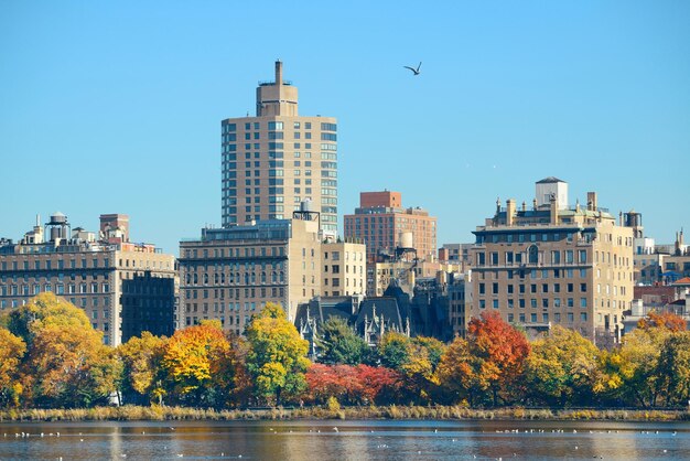 Central park Manhattan east side luxury building over lake in Autumn in New York City.