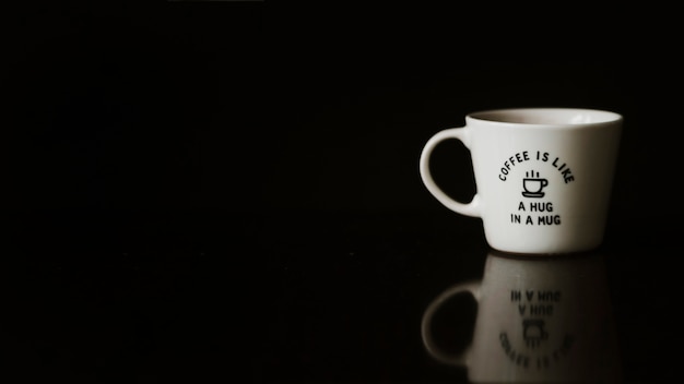 Free photo ceramic cup on reflective black background