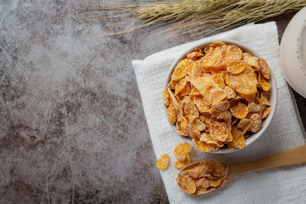 Cereal in bowl and milk on dark background