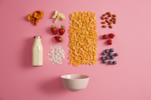 Free photo cereals with dried apples, dates, cashew, pistachio around bottle with milk