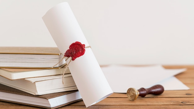 Free photo certificate with ribbon and bow on office desk