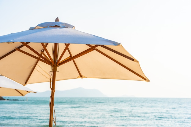 Chair umbrella and lounge on the beautiful beach sea ocean on sky