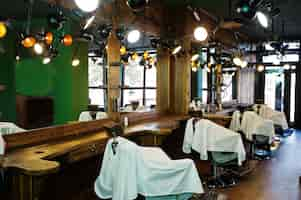 Free photo chairs in green male barbershop in retro style