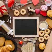 Free photo chalkboard amidst pastry and bakeware