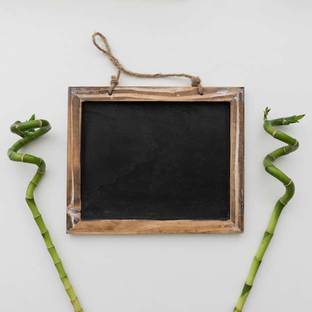 Free photo chalkboard framed by bamboo sticks