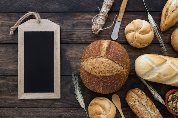 Chalkboard near buns and knives