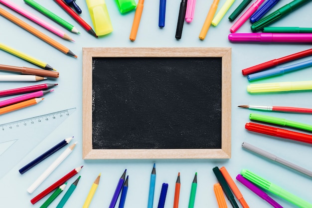 Chalkboard slate next to bright pencils